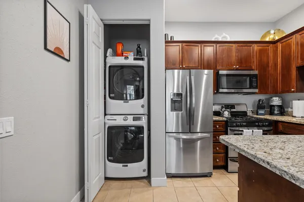 a kitchen with stainless steel appliances granite countertop a refrigerator and a sink