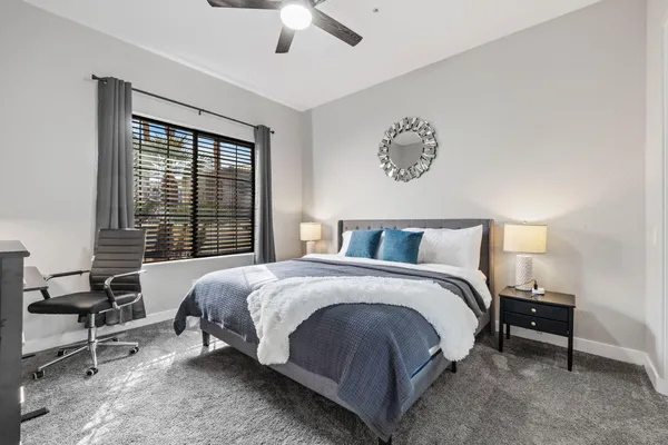 a bed room with a bed and a chair