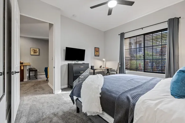 a bedroom with a bed and a flat screen tv