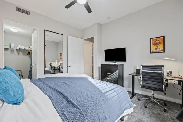 a bedroom with a bed and a flat screen tv