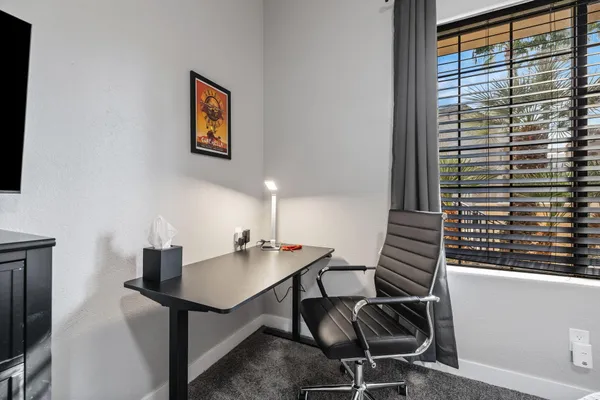 a work room with furniture and windows