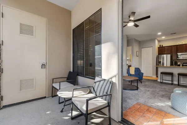 a living room with furniture and kitchen view