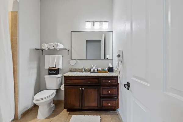 a bathroom with a toilet a sink and mirror