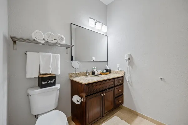 a bathroom with a toilet a sink and mirror