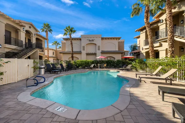 a view of a swimming pool with outdoor seating