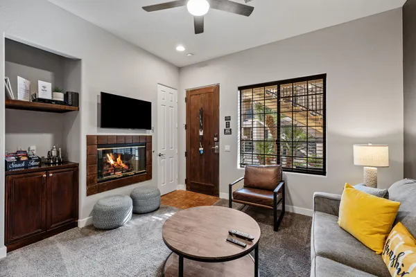 a living room with furniture a flat screen tv and a fireplace