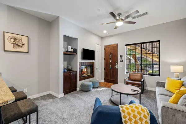 a living room with furniture a fireplace and a flat screen tv