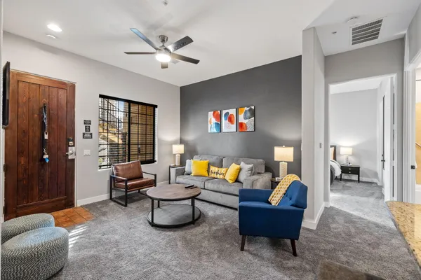 a living room with furniture and a chandelier