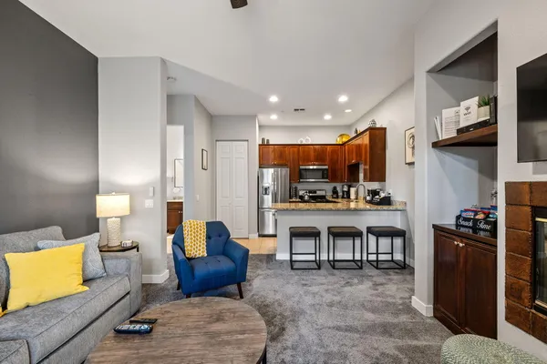 a living room with furniture and kitchen view