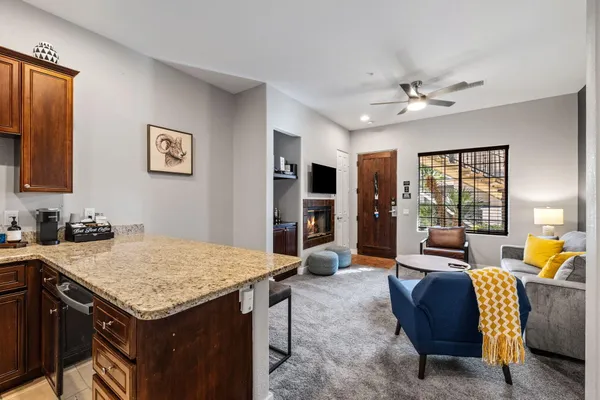 a living room with furniture and kitchen view