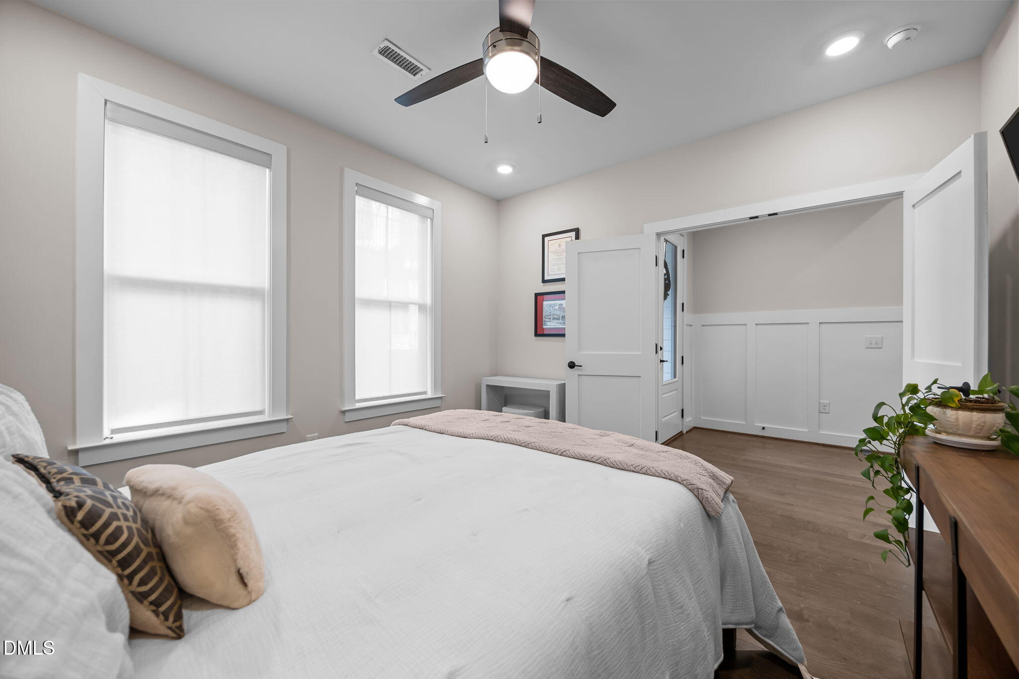 401 Bryan Pointe Drive, Unit 103 Raleigh, NC 27608 - Photo 11 of 43 a bedroom with a bed and a chandelier