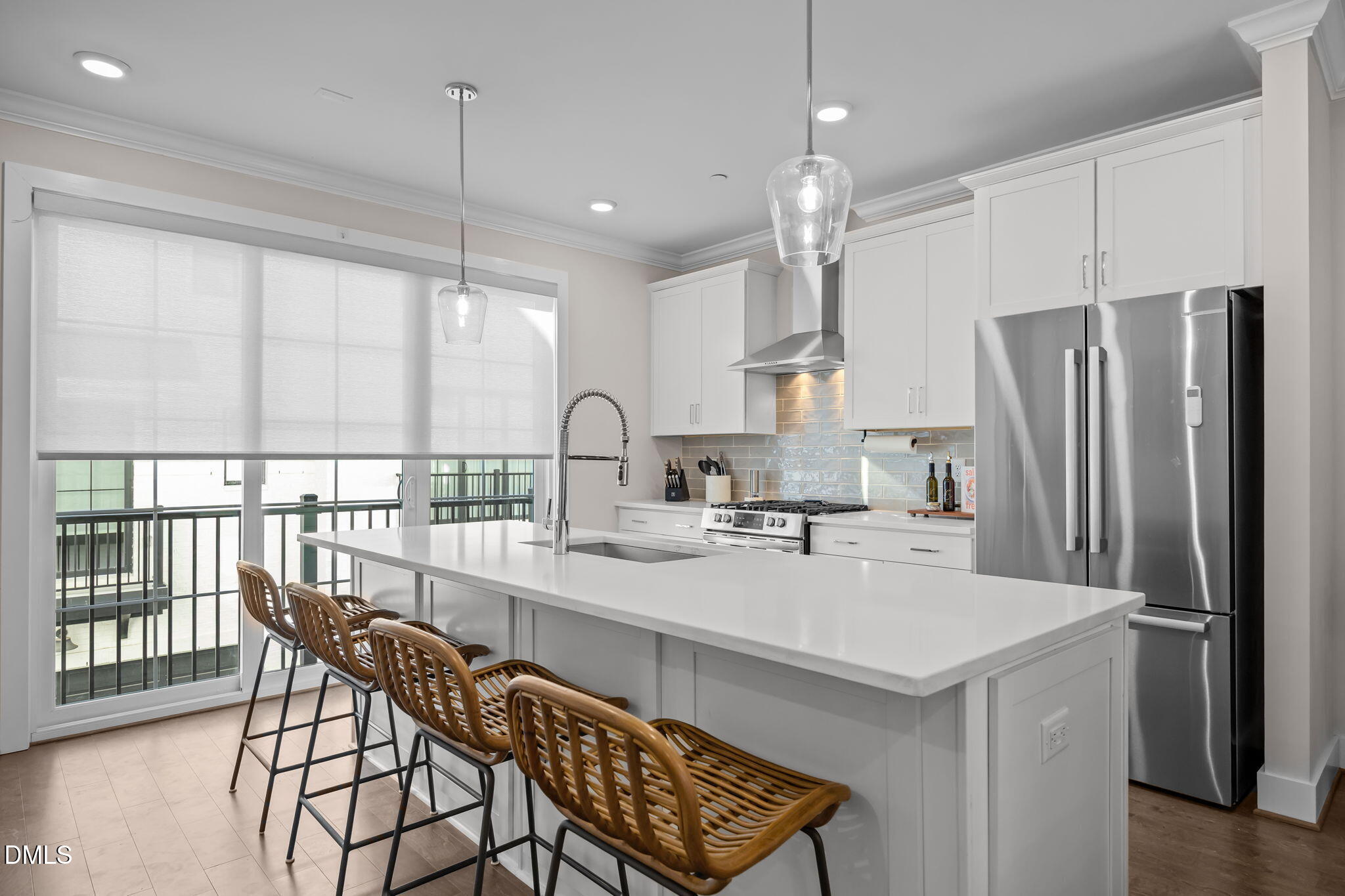 401 Bryan Pointe Drive, Unit 103 Raleigh, NC 27608 - Photo 12 of 43 a kitchen with stainless steel appliances a table chairs and a refrigerator