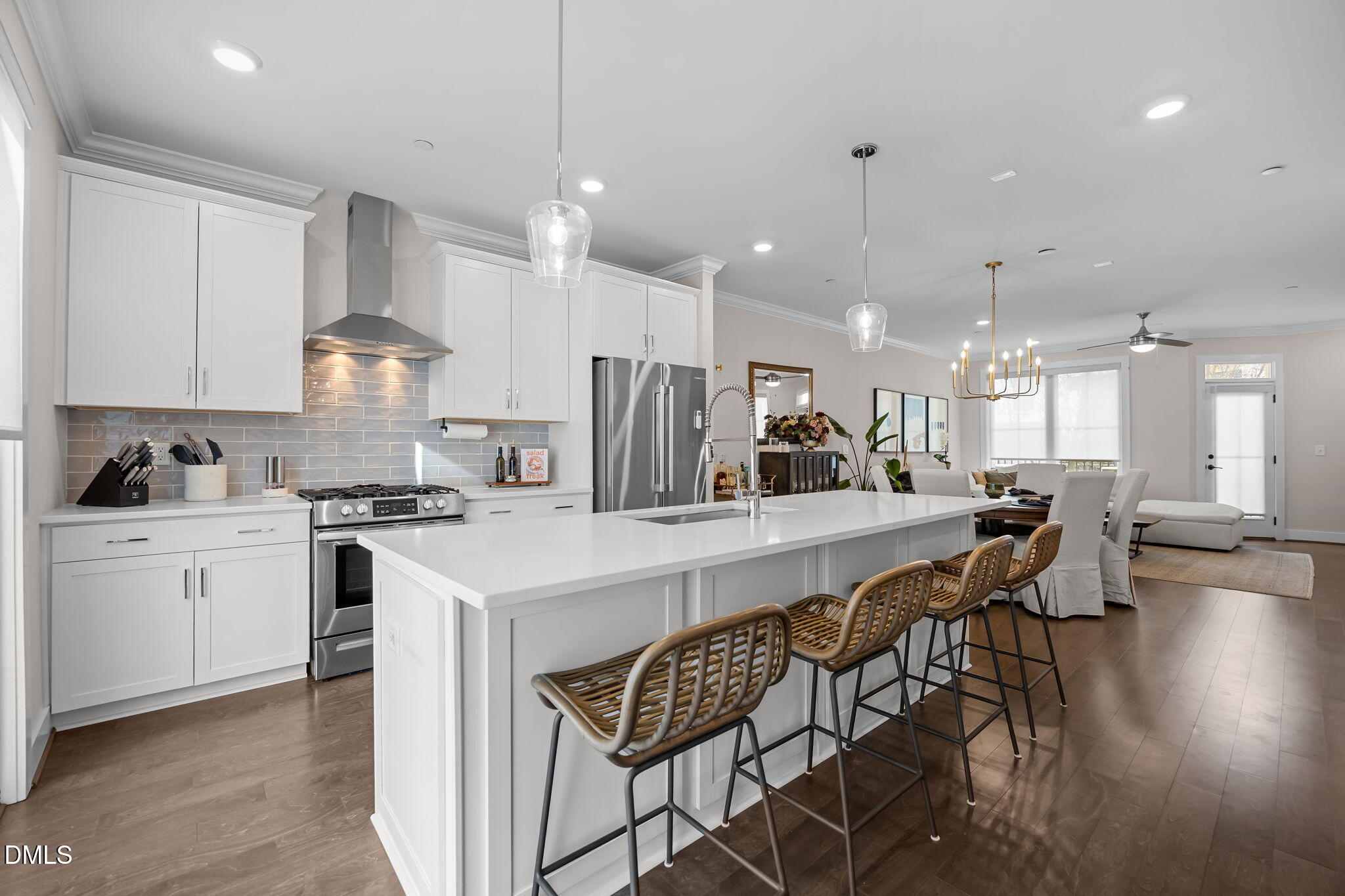 401 Bryan Pointe Drive, Unit 103 Raleigh, NC 27608 - Photo 13 of 43 a kitchen with stainless steel appliances kitchen island granite countertop a stove a sink a refrigerator and white cabinets with wooden floor