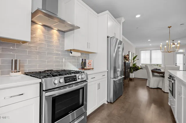 a kitchen with stove and refrigerator