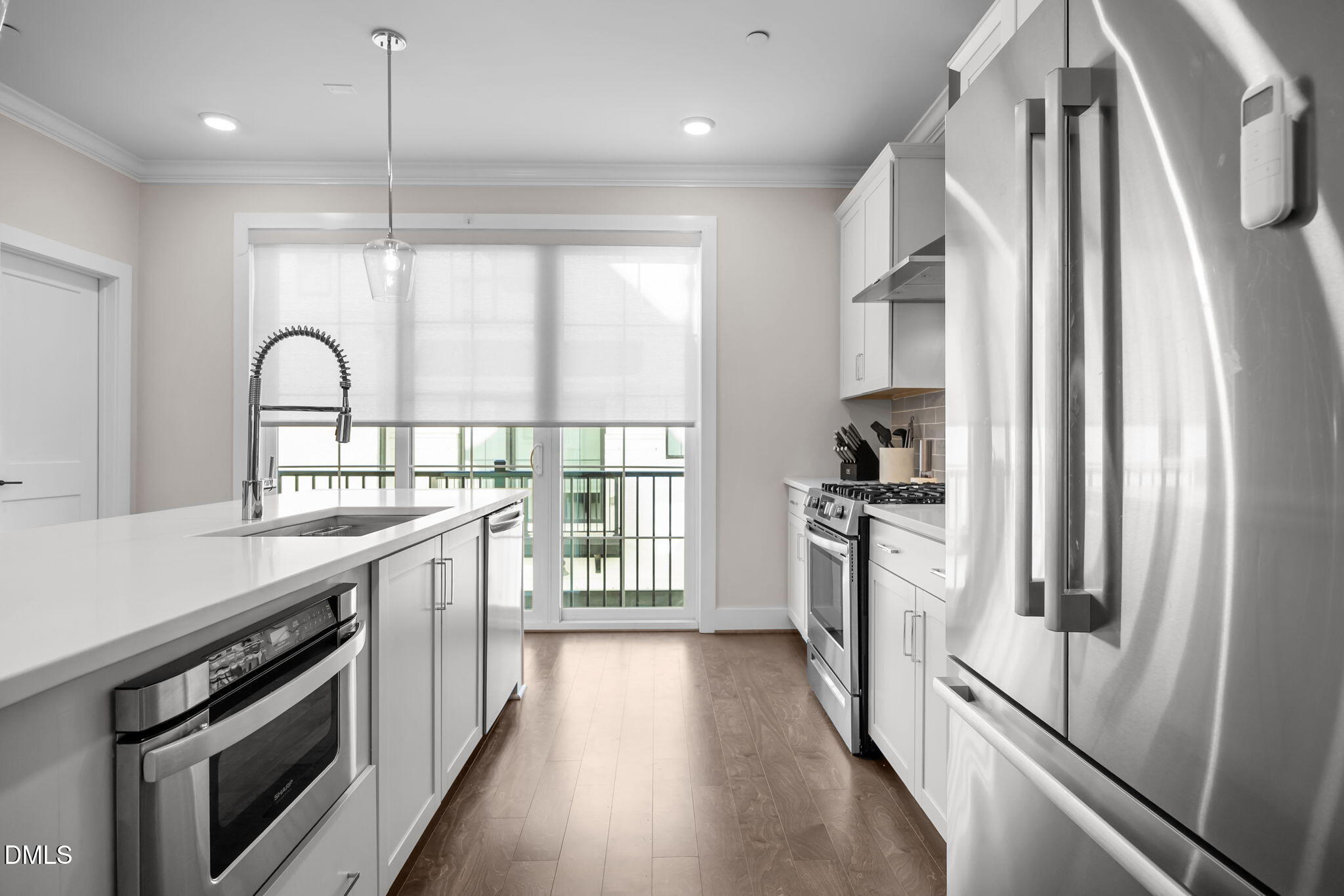 401 Bryan Pointe Drive, Unit 103 Raleigh, NC 27608 - Photo 18 of 43 a kitchen with stainless steel appliances granite countertop a refrigerator a stove and a sink