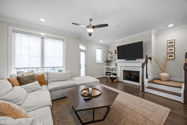 a living room with furniture a fireplace and a flat screen tv