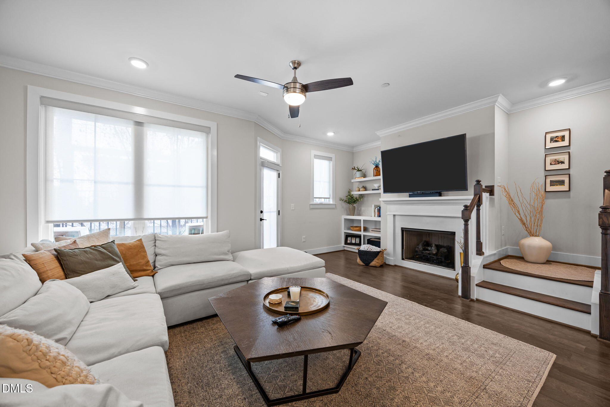 401 Bryan Pointe Drive, Unit 103 Raleigh, NC 27608 - Photo 21 of 43 a living room with furniture a fireplace and a flat screen tv