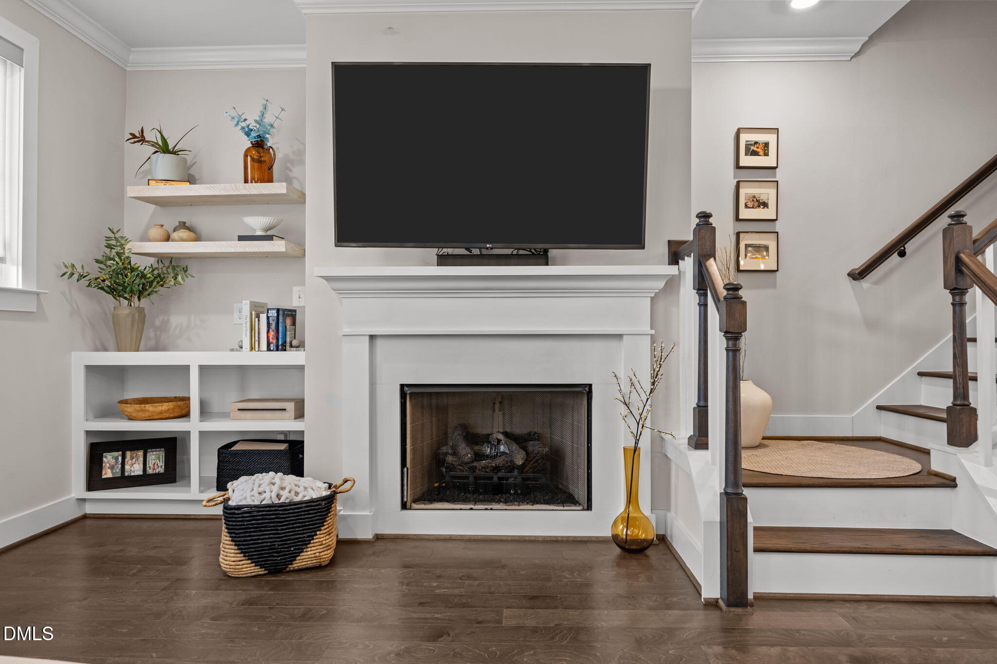 401 Bryan Pointe Drive, Unit 103 Raleigh, NC 27608 - Photo 22 of 43 a living room with a fireplace and a flat screen tv
