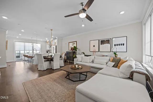 a living room with furniture and a view of kitchen