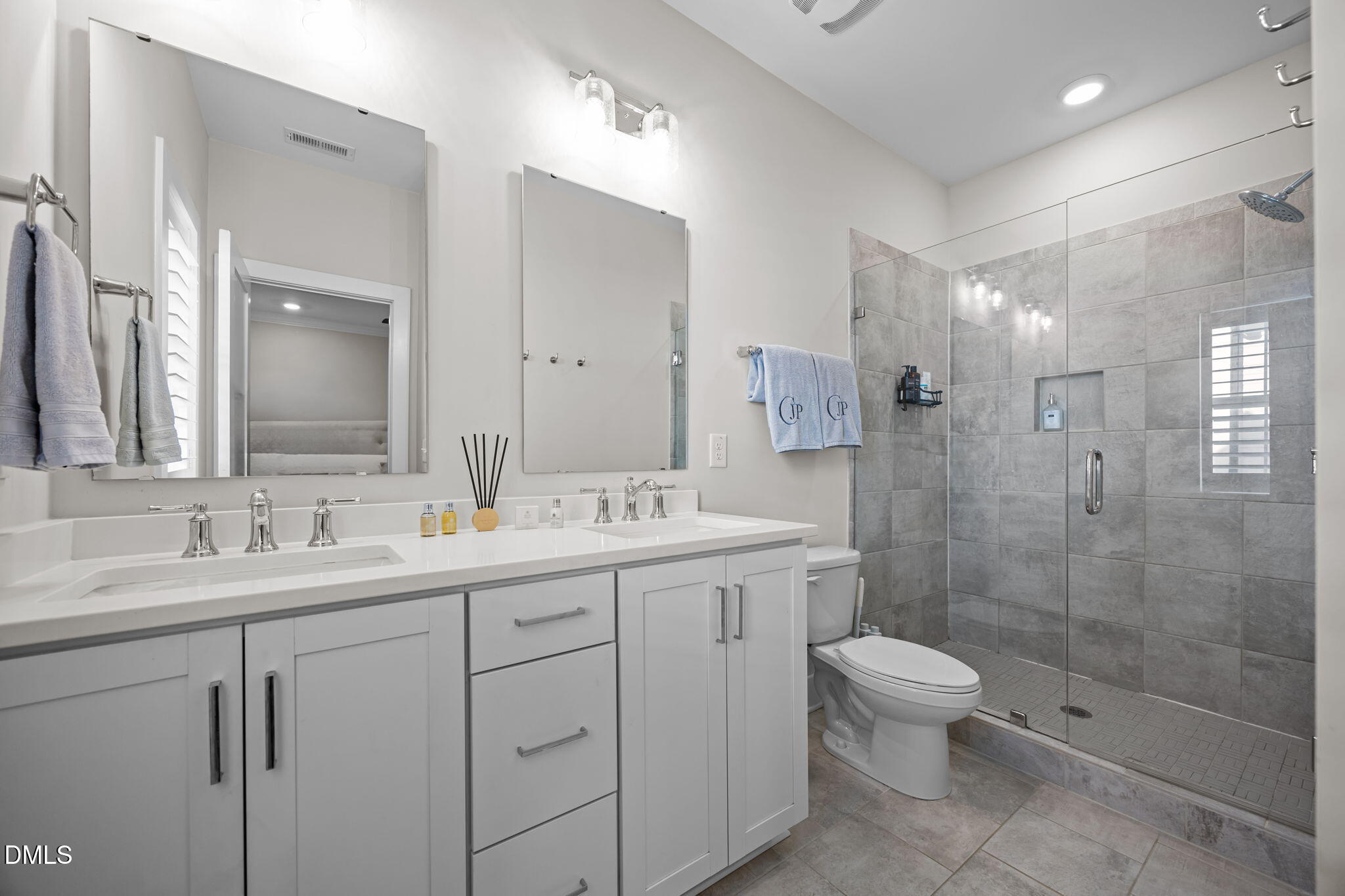 401 Bryan Pointe Drive, Unit 103 Raleigh, NC 27608 - Photo 31 of 43 a bathroom with a double vanity sink toilet and shower