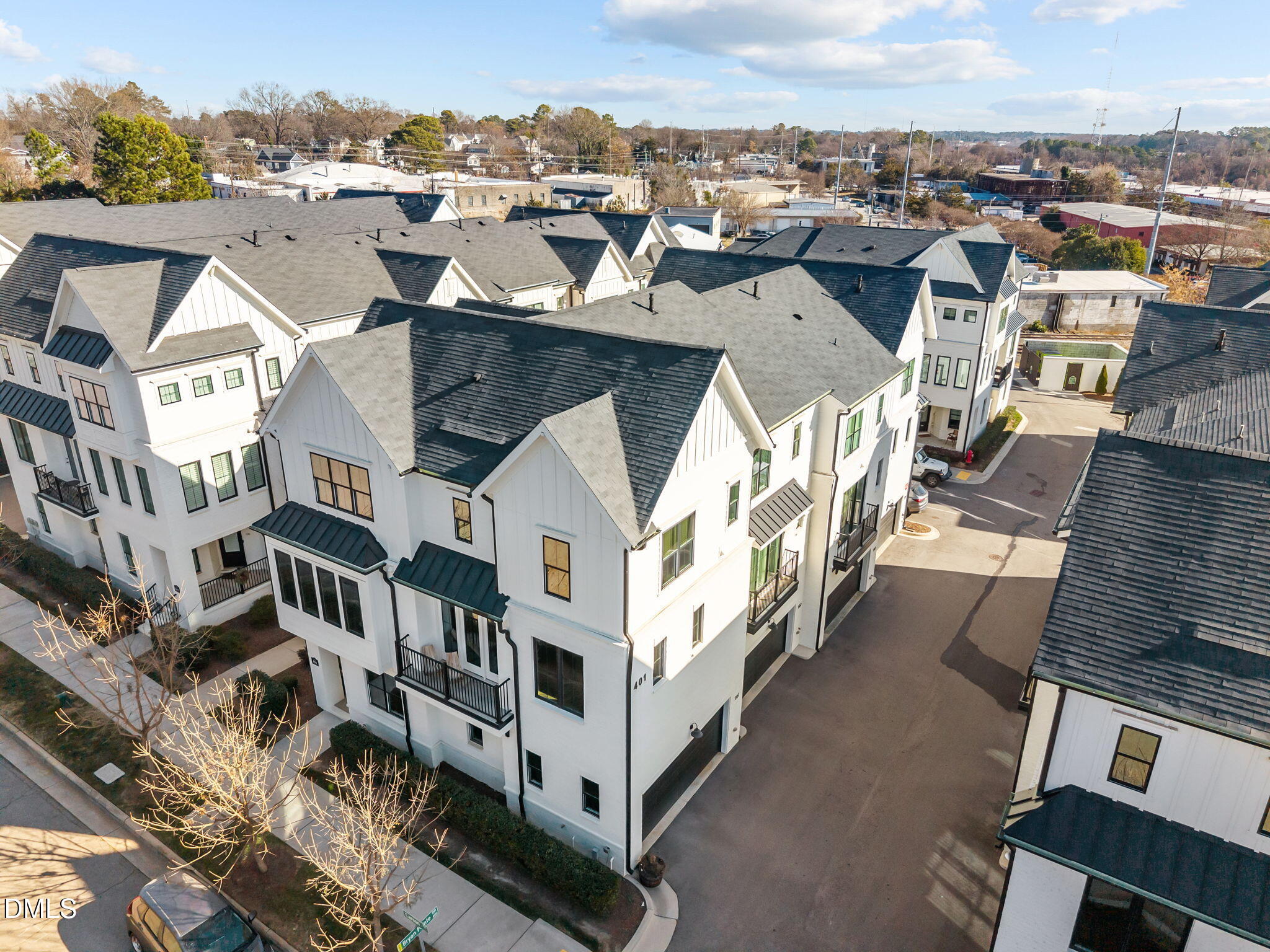 401 Bryan Pointe Drive, Unit 103 Raleigh, NC 27608 - Photo 38 of 43 a view of a white building among the city with lots of buildings