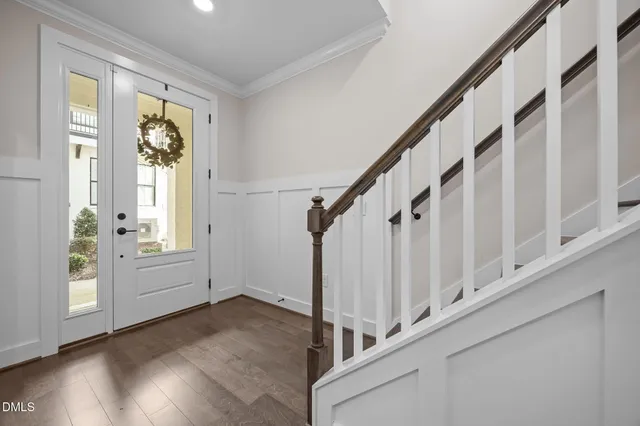 a view of an entryway with wooden floor and windows