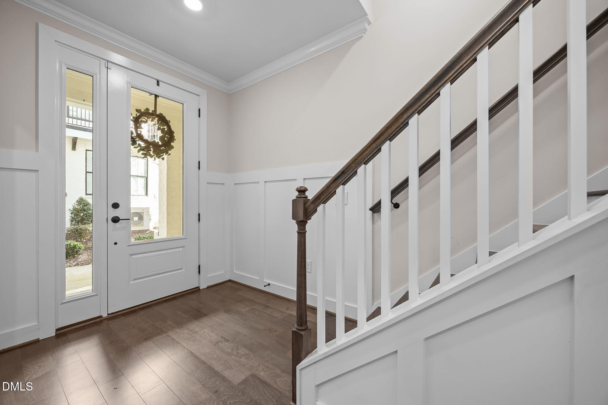 401 Bryan Pointe Drive, Unit 103 Raleigh, NC 27608 - Photo 7 of 43 a view of an entryway with wooden floor and windows