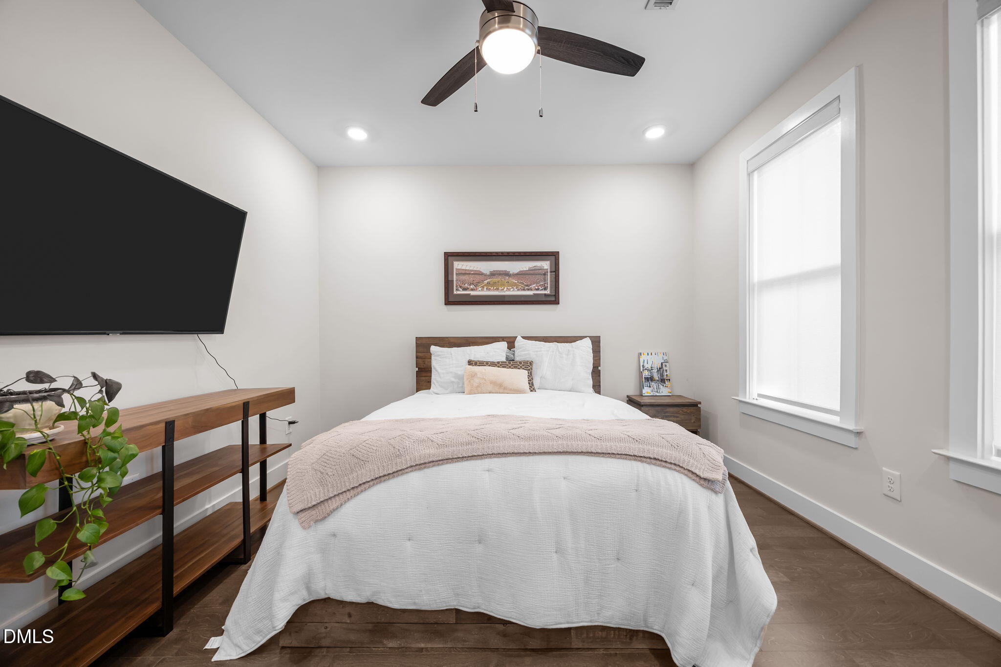 401 Bryan Pointe Drive, Unit 103 Raleigh, NC 27608 - Photo 10 of 43 a bedroom with a bed window and a flat screen tv