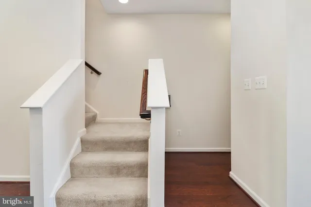 a view of staircase with white walls