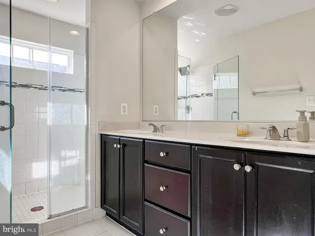 a bathroom with a sink double vanity and shower
