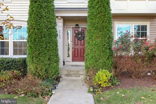 a view of a house with potted plants