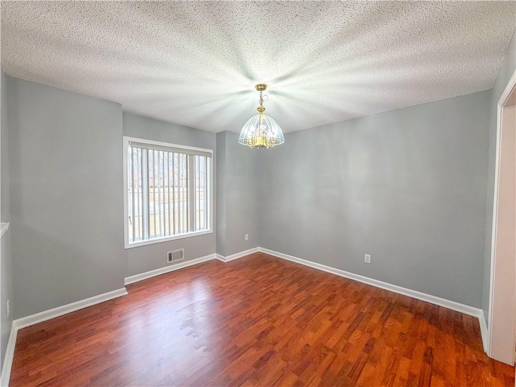2950 Mandy Court Jonesboro, GA 30236 - Photo 13 of 40 wooden floor in an empty room with a window