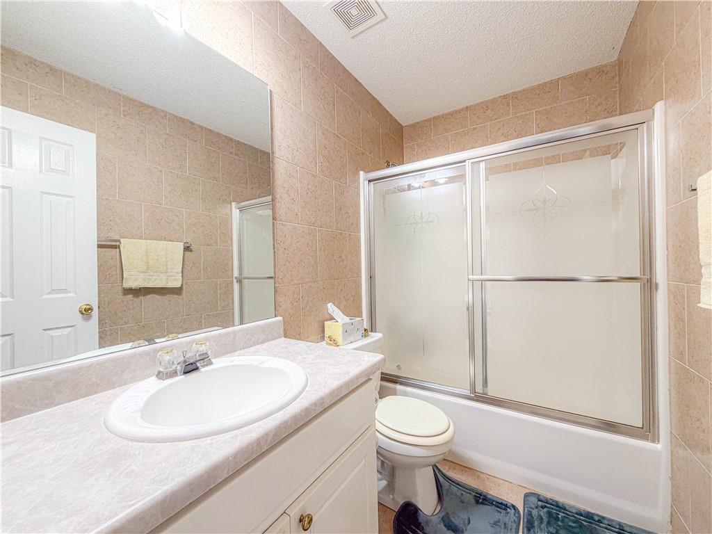 2950 Mandy Court Jonesboro, GA 30236 - Photo 18 of 40 a bathroom with a granite countertop sink toilet and shower