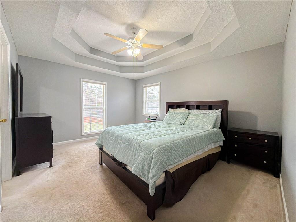 2950 Mandy Court Jonesboro, GA 30236 - Photo 19 of 40 a spacious bedroom with a bed and a chandelier