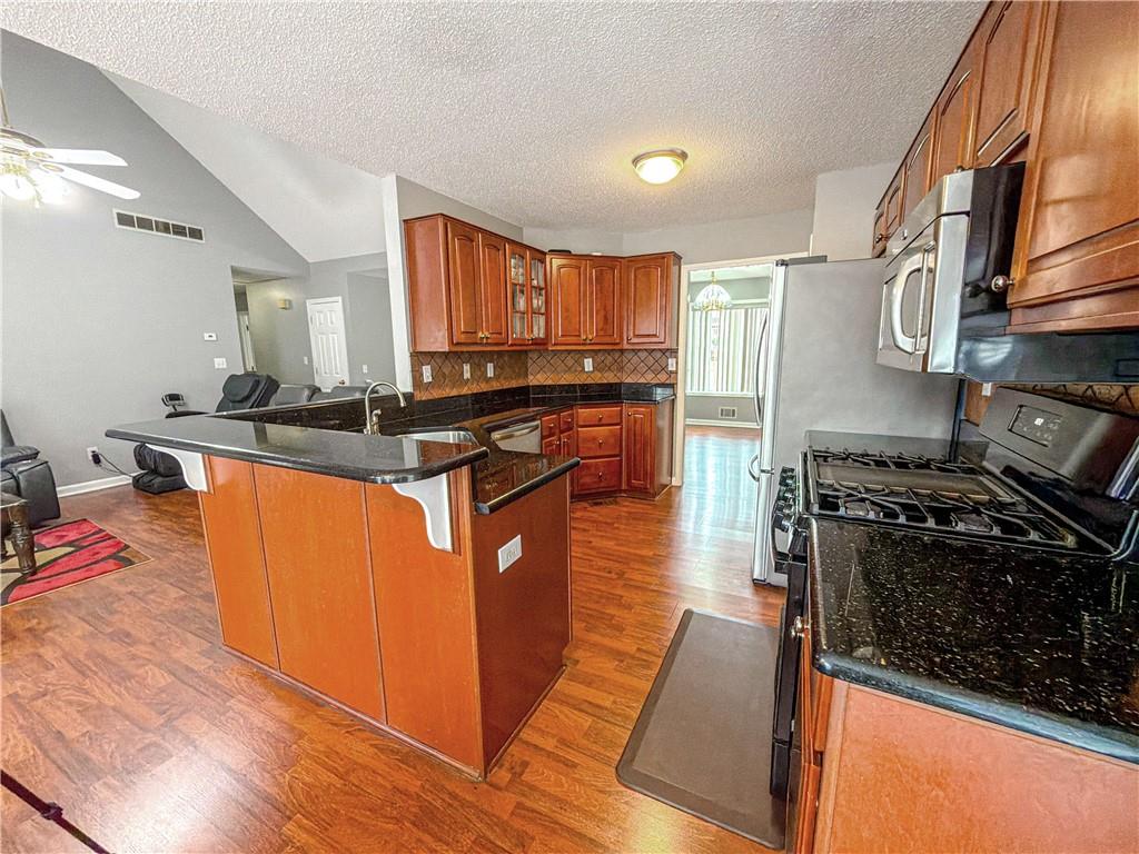 2950 Mandy Court Jonesboro, GA 30236 - Photo 10 of 40 a kitchen with stainless steel appliances granite countertop a stove a sink and a microwave