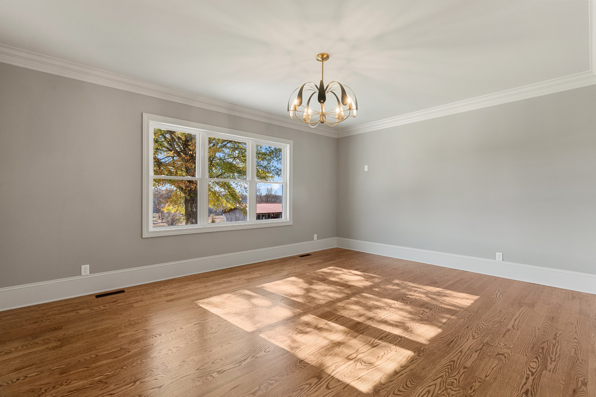 4818 Hickory Ridge Road Lebanon, TN 37087 - Photo 23 of 73 an empty room with wooden floor chandelier and window