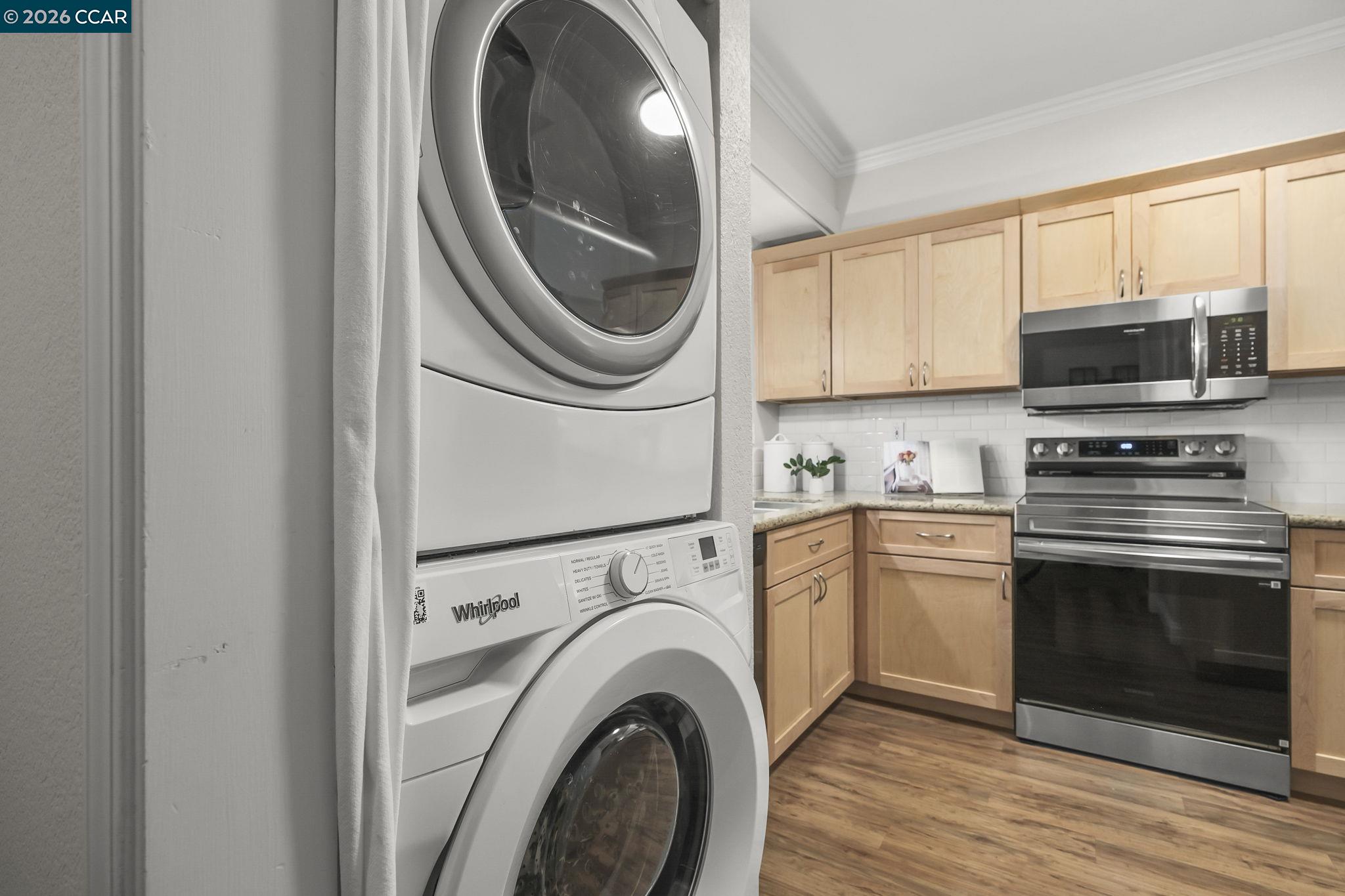 2586 Oak Road, Unit 130 Walnut Creek, CA 94597 - Photo 21 of 31 a kitchen with a stove a washer and dryer next to a window