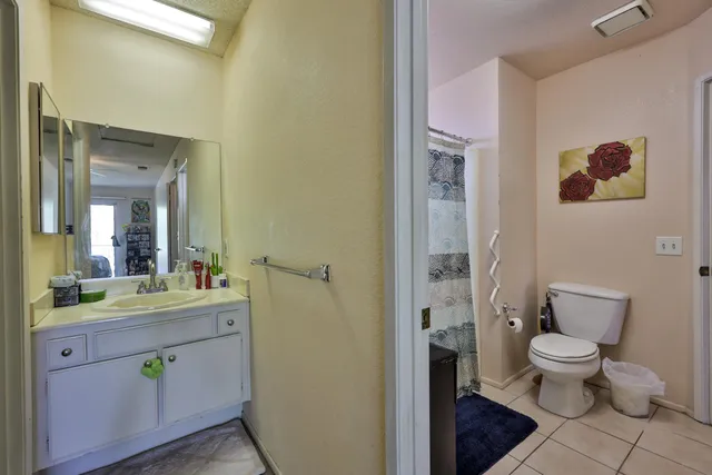 a spacious bathroom with a toilet sink and a mirror