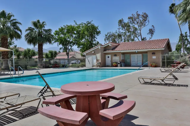 a view of house with swimming pool outdoor seating