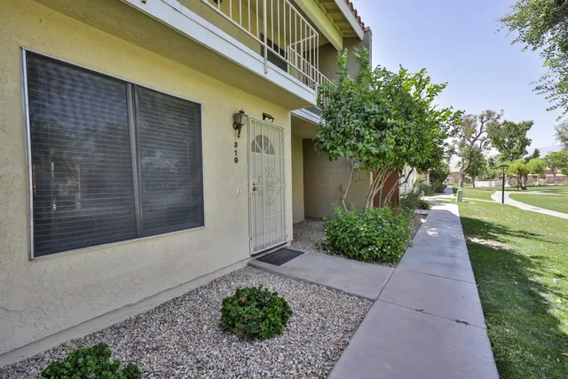 a view of a pathway both side of the house