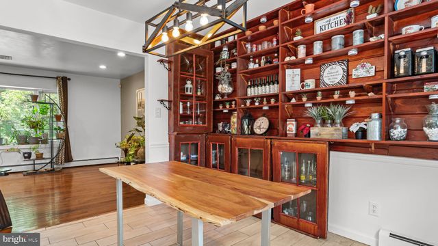 a view of a room that has a table and chairs in it