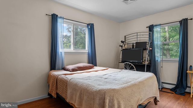 a bedroom with a bed and flat screen tv