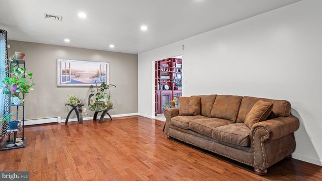 a living room with furniture and flowers