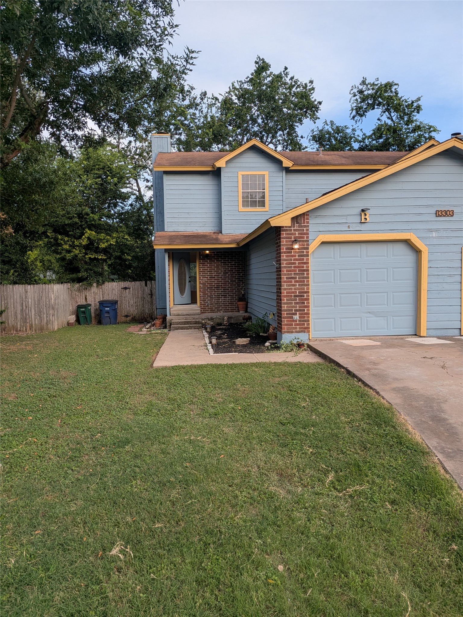 13303 Lyndhurst Street, Unit B Austin, TX 78729 - Photo 1 of 13 A well-maintained lawn welcomes you to this home with brick accents and an attached garage.