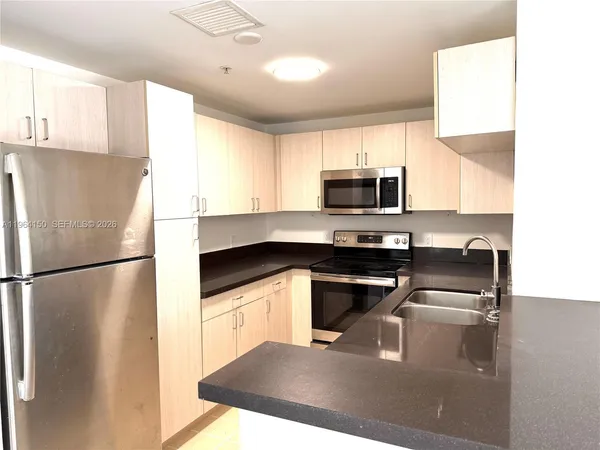 a kitchen with a refrigerator sink and microwave