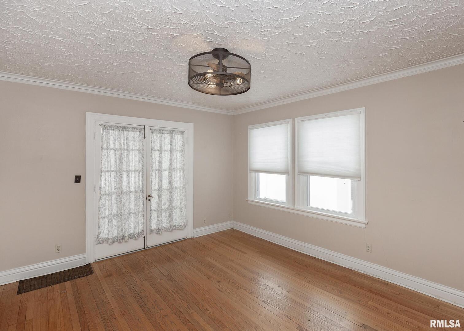 2416 12th Street Moline, IL 61265 - Photo 12 of 41 an empty room with wooden floor and windows