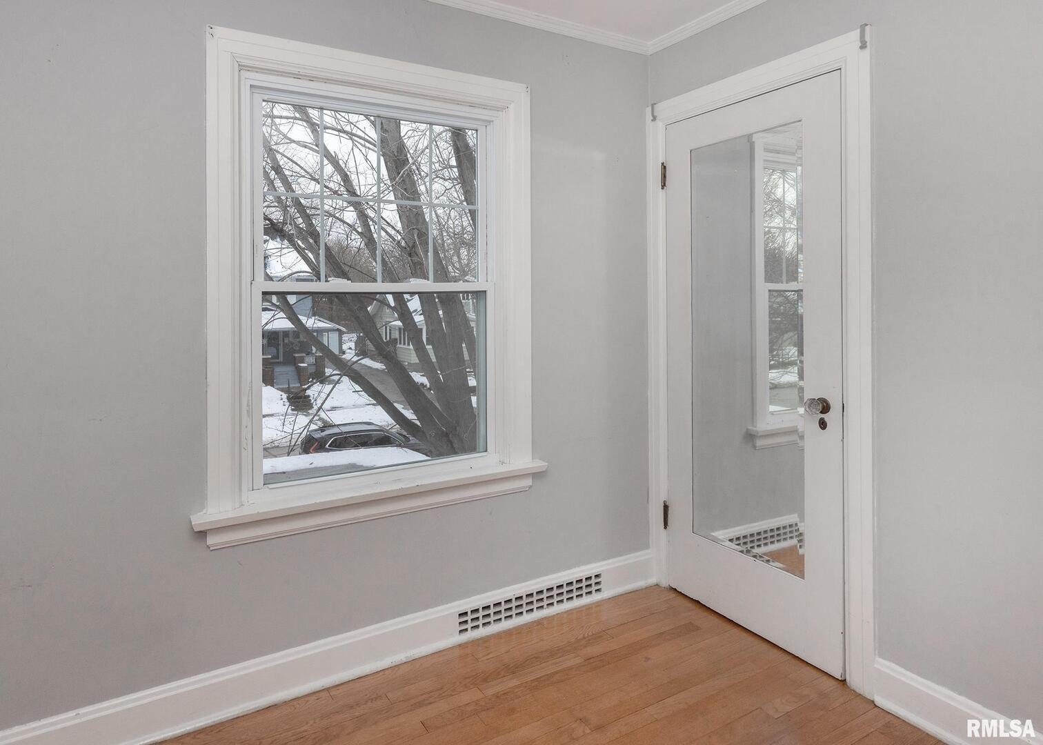 2416 12th Street Moline, IL 61265 - Photo 23 of 41 a view of an empty room with window and wooden floor