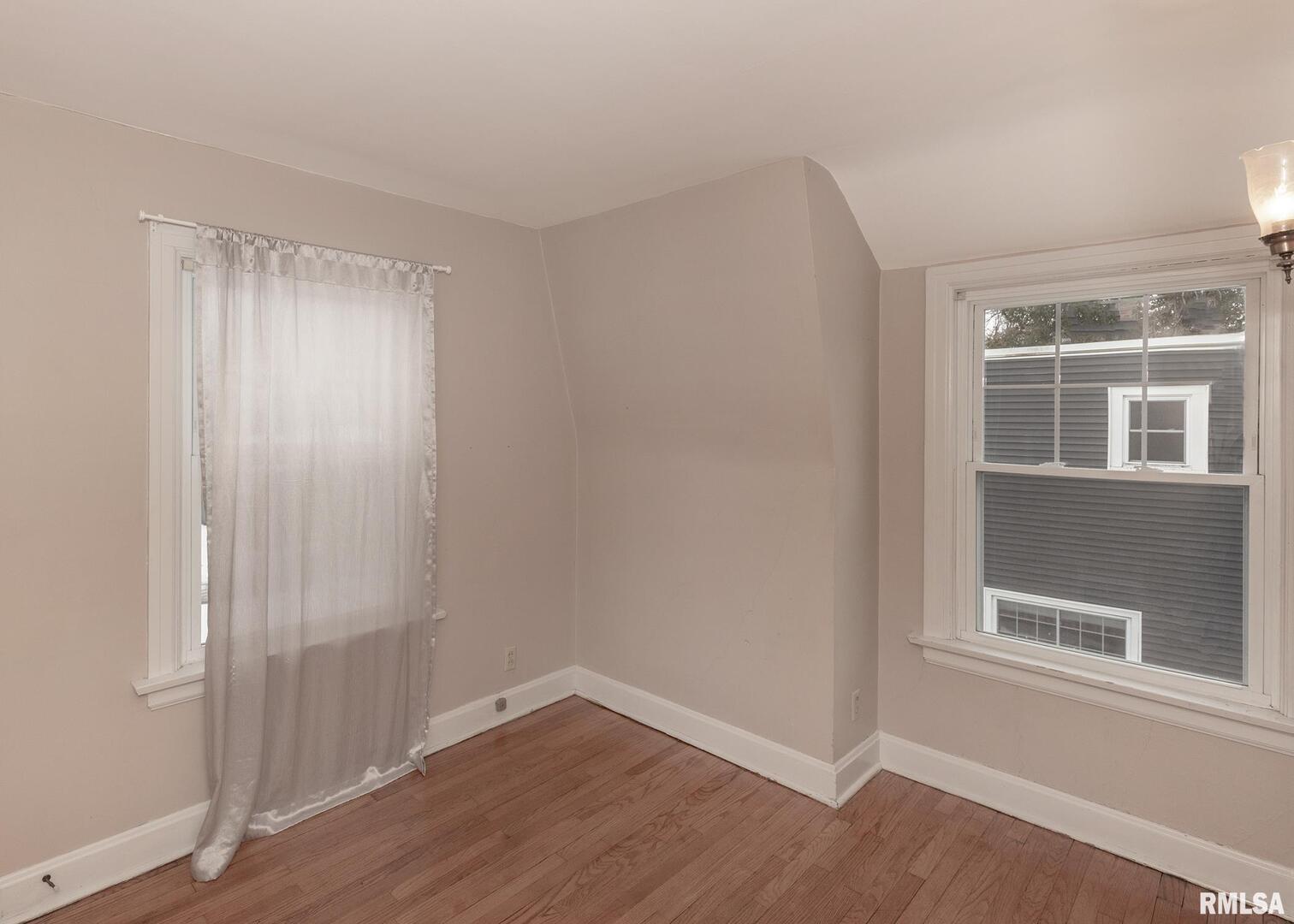 2416 12th Street Moline, IL 61265 - Photo 24 of 41 a view of an empty room with wooden floor and a window
