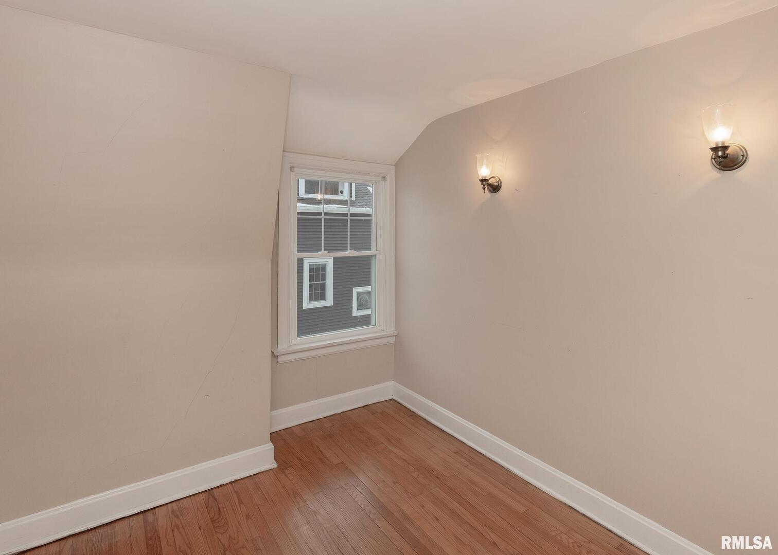 2416 12th Street Moline, IL 61265 - Photo 26 of 41 a view of empty room with wooden floor and fan