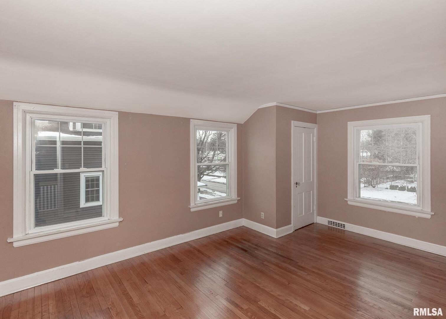 2416 12th Street Moline, IL 61265 - Photo 27 of 41 an empty room with wooden floor and windows